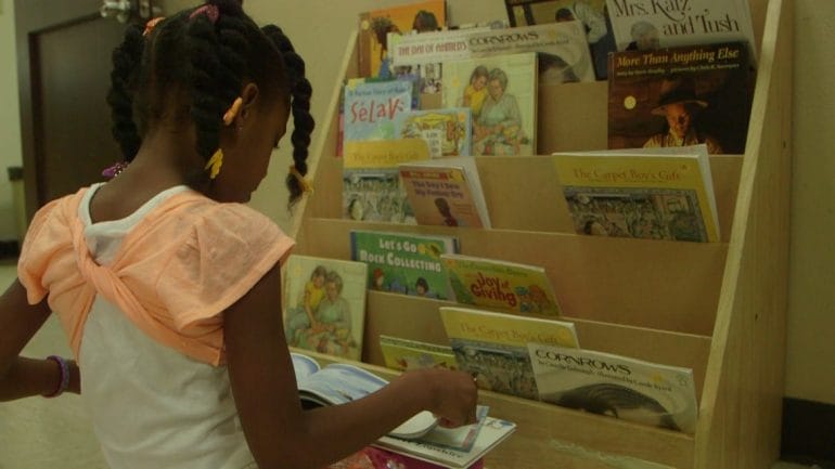 Girl choosing books from shelf