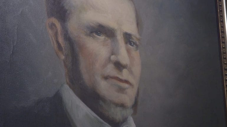 Close up picture of 1800s portrait of a man.
