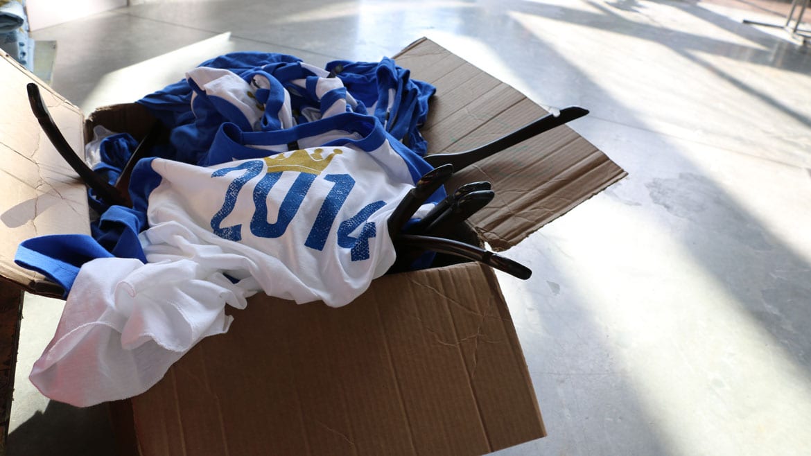 a pile of blue and white baseball T-shirts with