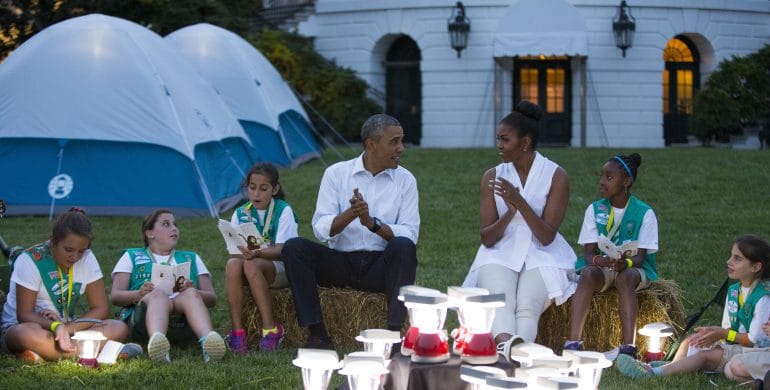 President Obama and Michelle Obama entertain during a Girl Scout campout on the South Lawn earlier this summer. The question is whether survivalist Bear Grylls is going allow the president to bring those lanterns on their trek. (Photo: Evan Vucci | AP)