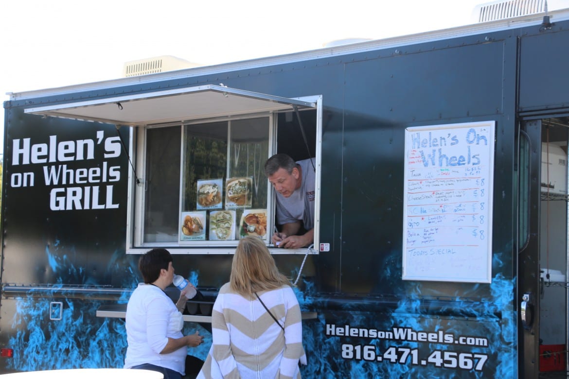 Food truck owner takes orders from two females.