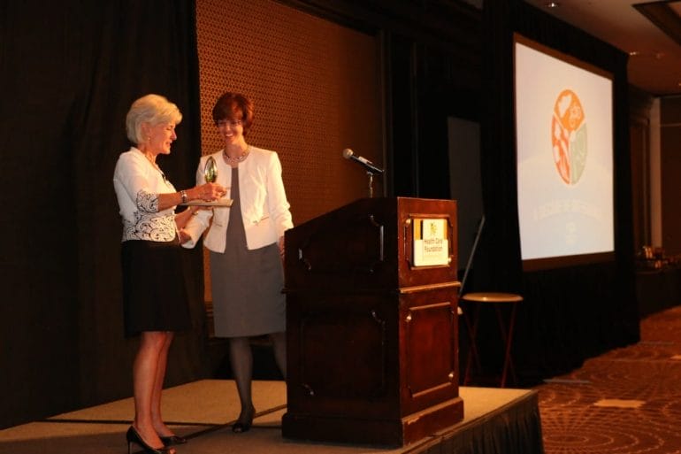 Dr. Bridget McCandless gives award to Kathleen Sebelius