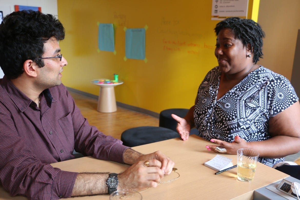 Catina Taylor talks with Aditya Voleti at a meeting