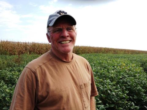Fifth-generation farmer Richard Oswald stands in a field of soybeans that's worth a lot less than it would have been last year, partly thanks to a downturn in the economy of China. (Photo: Frank Morris | Harvest Public Media)