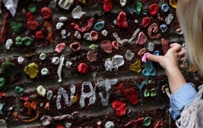 One more piece of gum is added to the estimated more than 750,000 pieces in Post Alley in Seattle. (Photo: Alan Berner |The Seattle Times)