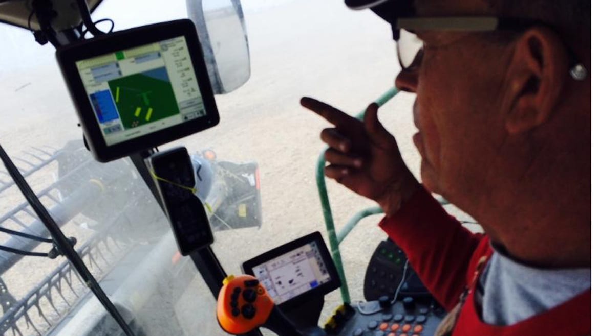 Blake Hurst, president of the Missouri Farm Bureau, in the cab of his combine, harvesting soybeans on his family's northern Missouri farm. He's watching satellite monitors that show yields, moisture content and fertilizer use. (Photo: Peggy Lowe | Harvest Public Media)