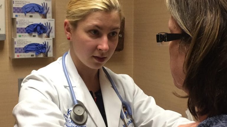 KU Med student Maria Iliakova examines a patient at the free JayDoc clinic in Kansas City, Kansas.