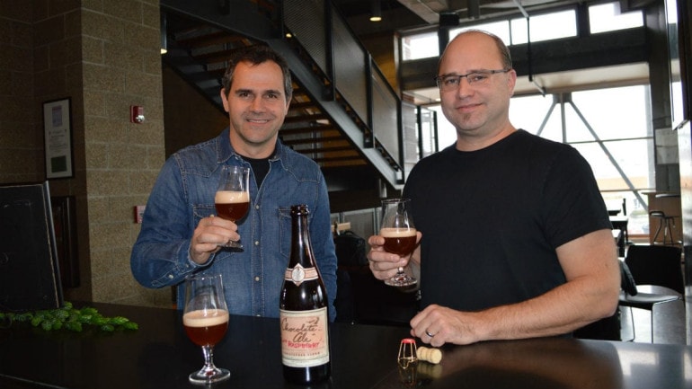 Boulevard brewmaster Steven Pauwels and chocolatier Christopher Elbow toast their latest collaboration: Chocolate Ale with Raspberry. (Photo: Jonathan Bender | Flatland)
