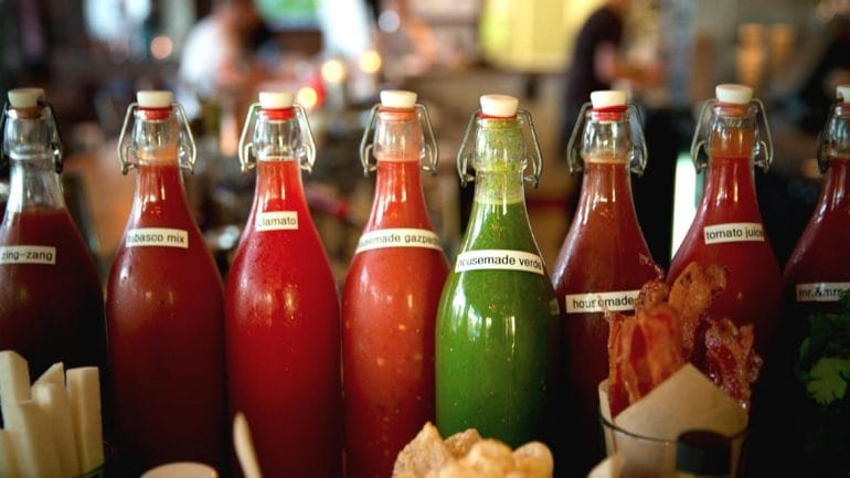 A shot of bottles holding Bloody Mary ingredients.