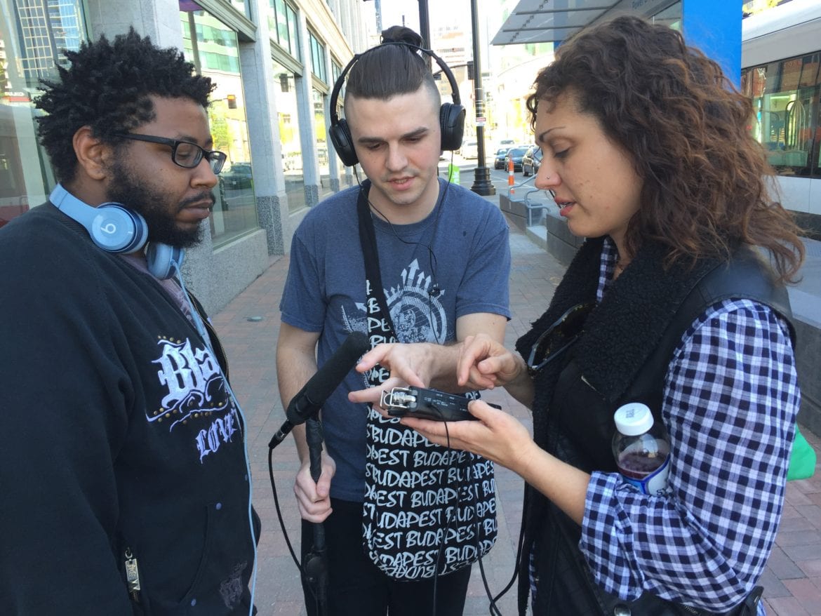 Three filmmakers talking on the street
