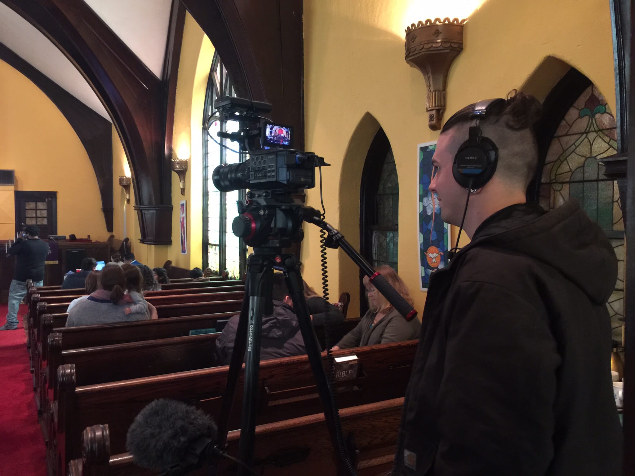 A cameraman in a church