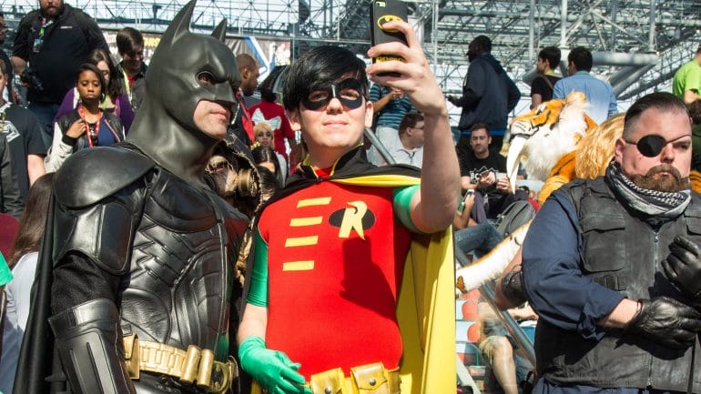 Two grown men dressed as batman and robin