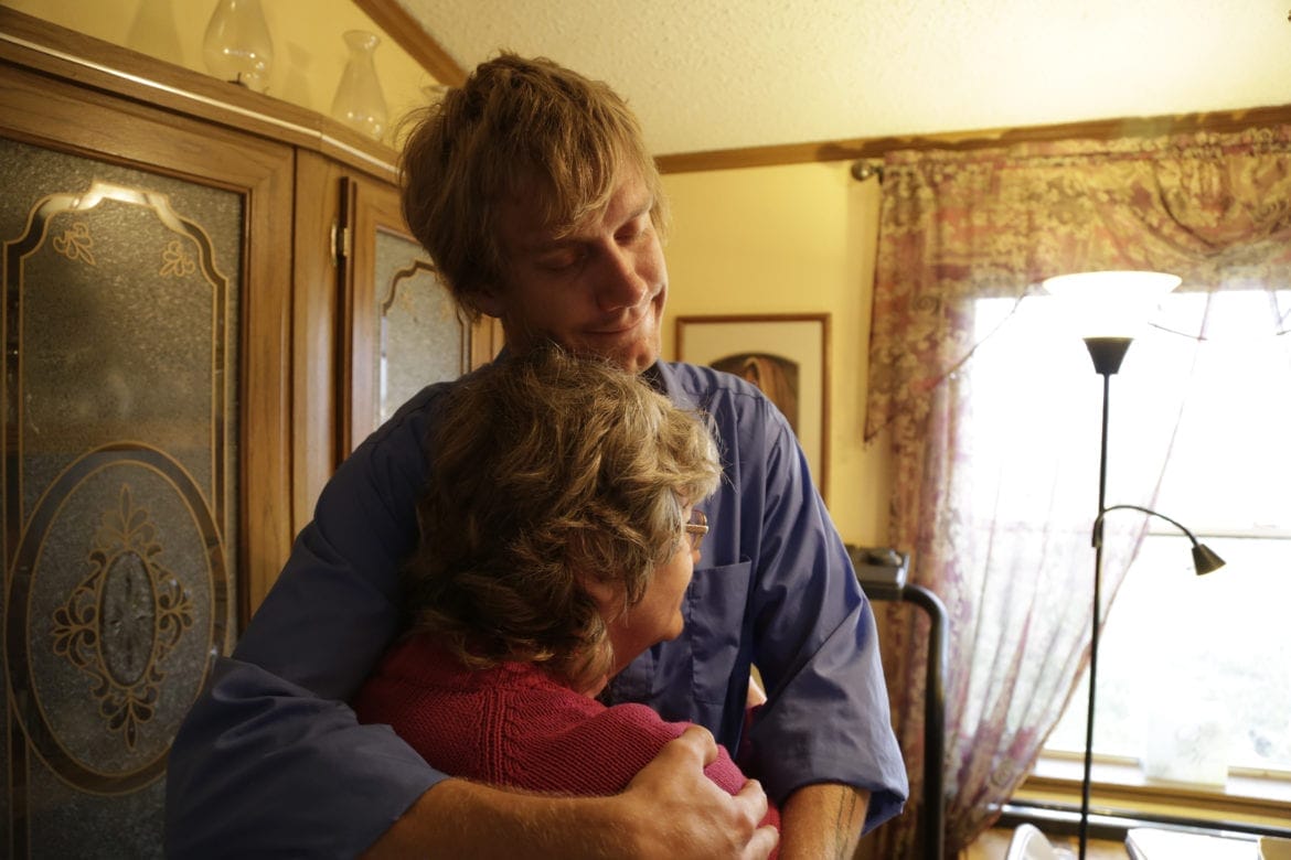 A son hugs his mother