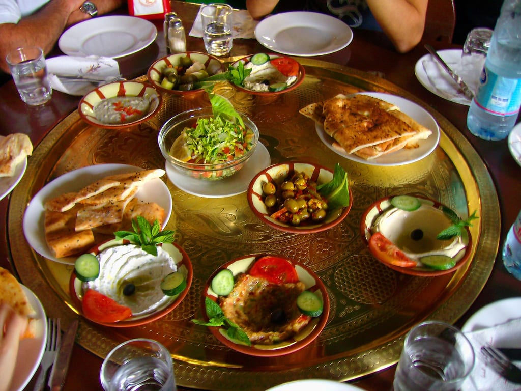 This photo shows food commonly served during Ramadan, including an entree of beef or chicken, a salad, and rice.