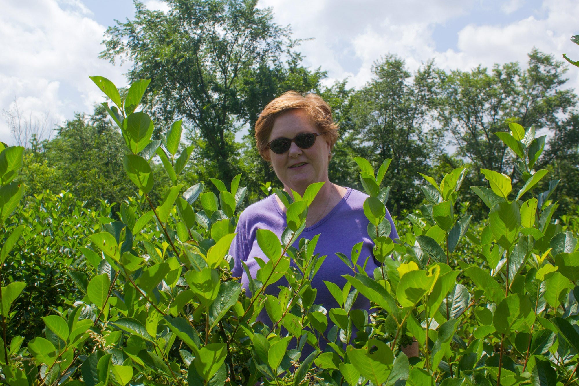 Peggy Fogle stands in her garden.