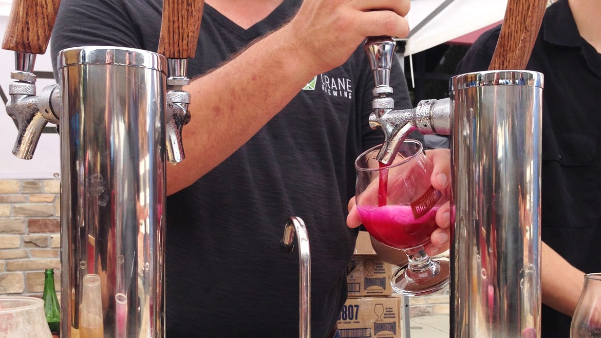 A pink beer being poured.