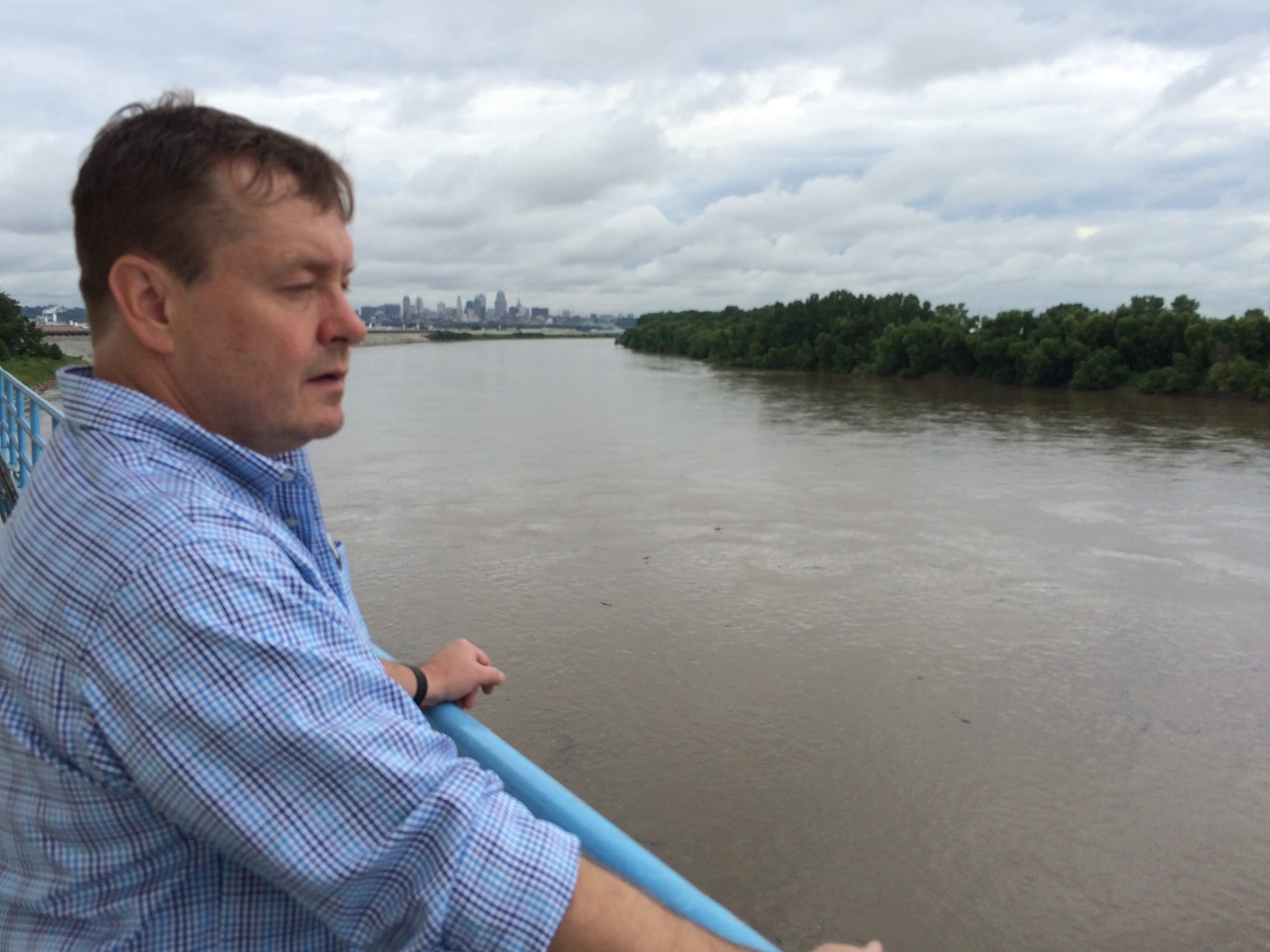 A man standing by a river.