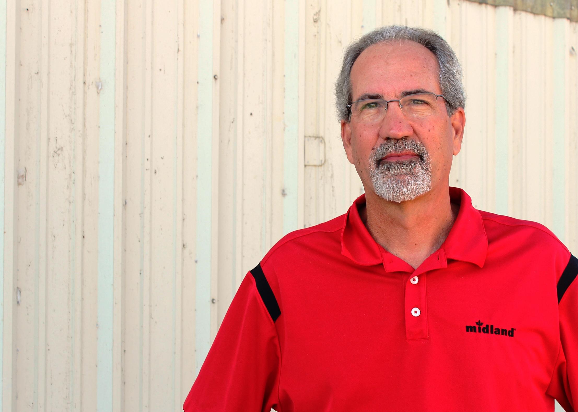 A man standing by a wall.