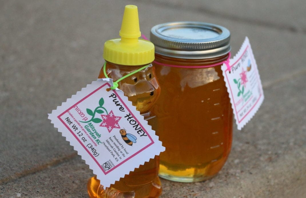a bottle and jar of the honey produced at the garden