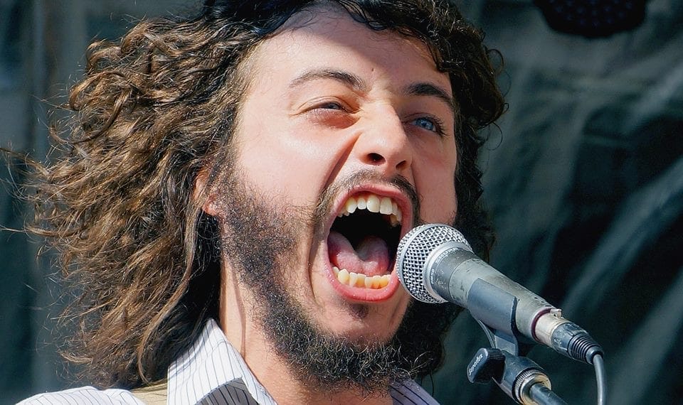 A man screaming into a microphone.
