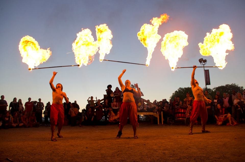 Fire twirlers perform.