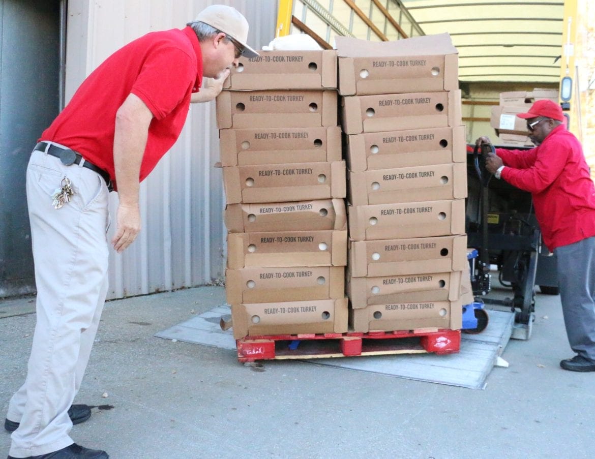 Salvation Army workers loading turkey on to a truck for transport to be cooked