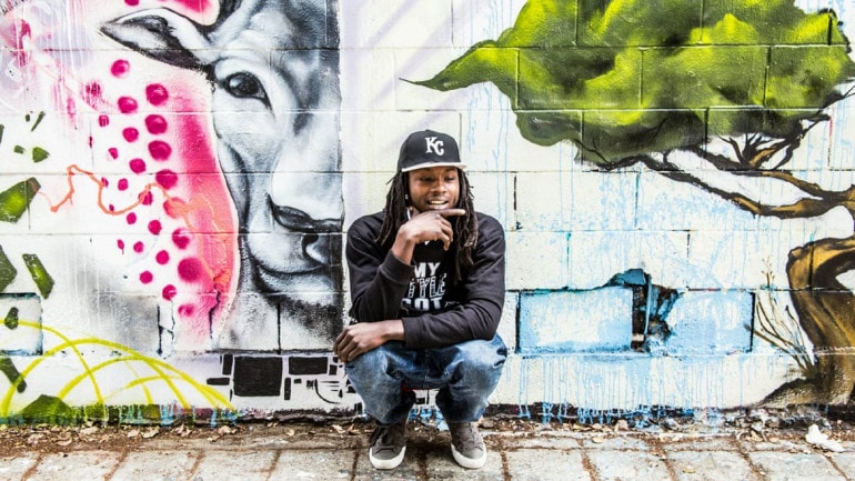 A rapper in front of graffiti