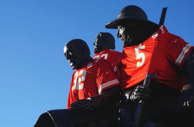 A statue dressed in Chiefs shirts.
