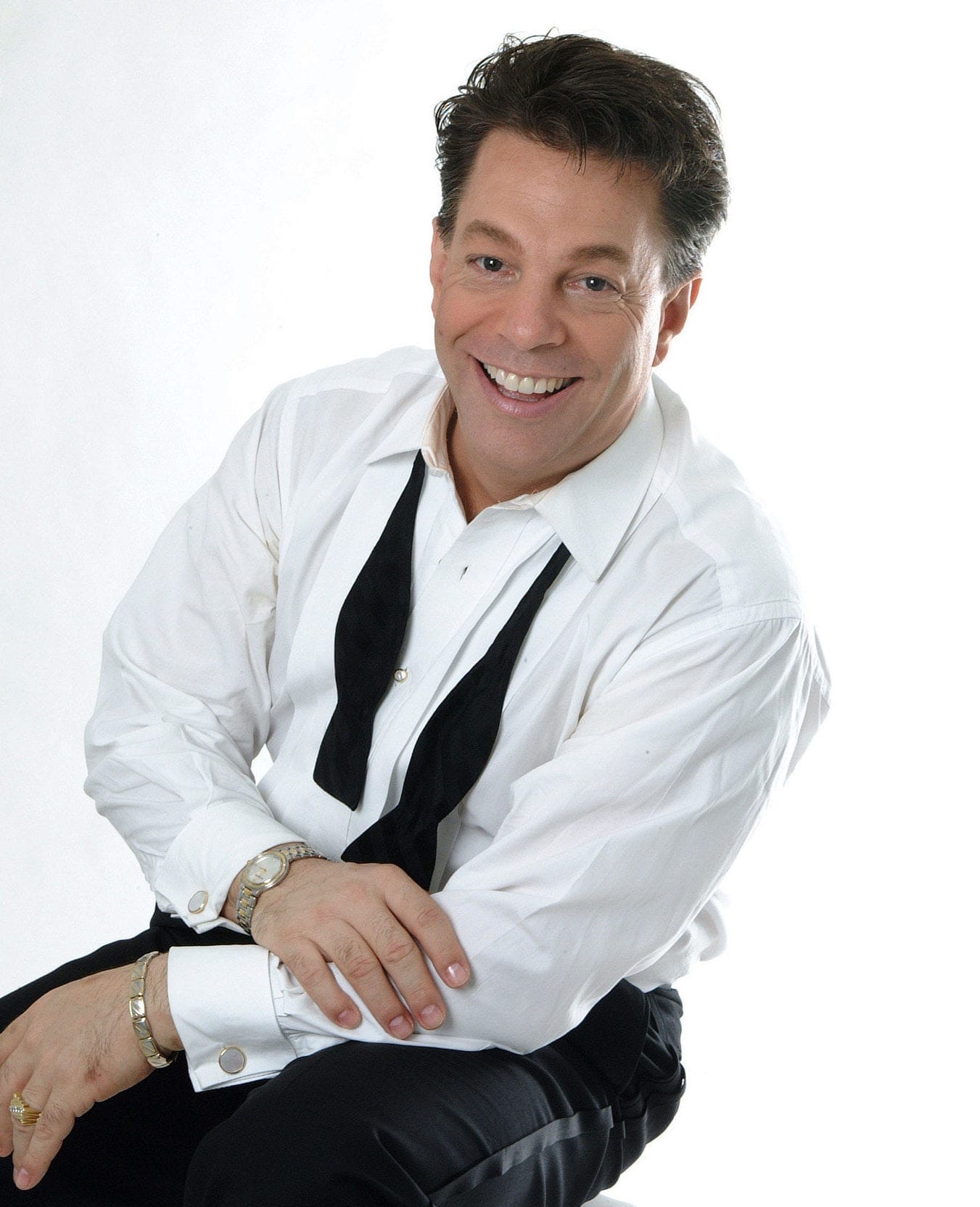 A man posing in a tuxedo.