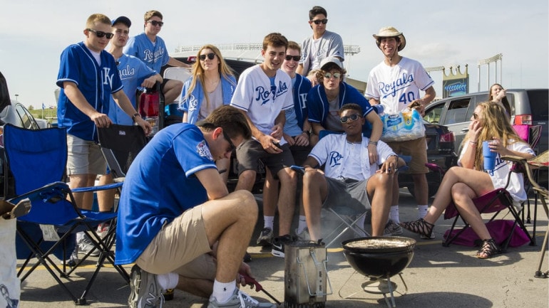 Tailgaters light a charcoal fire at Kauffman Stadium