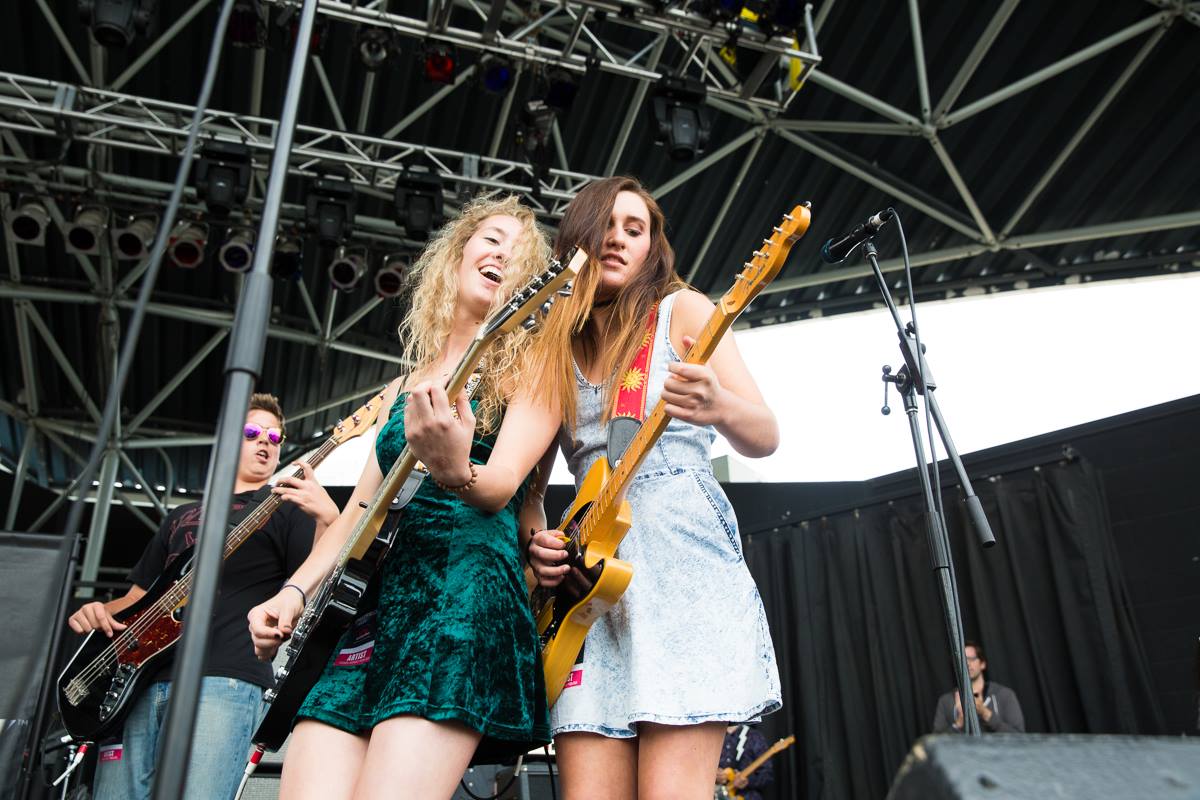 Two young women rock out on guitars
