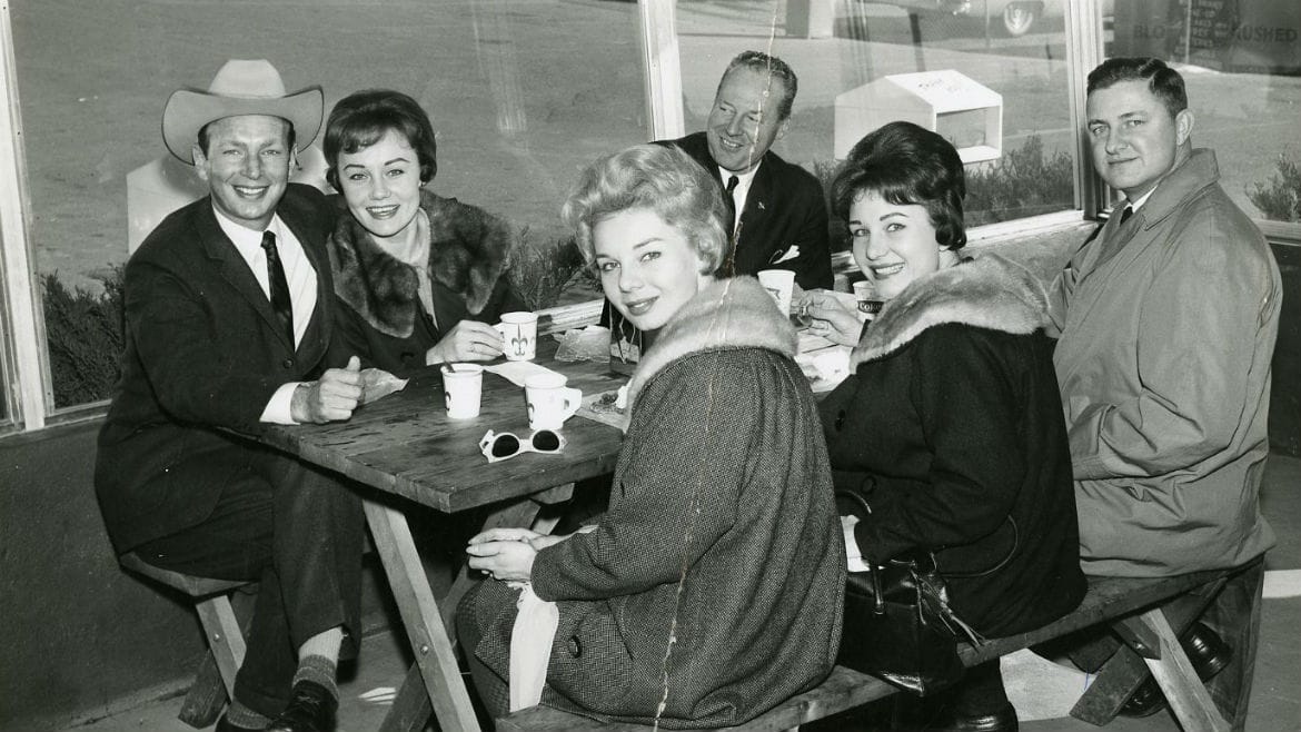 Group of women and men smiling at table