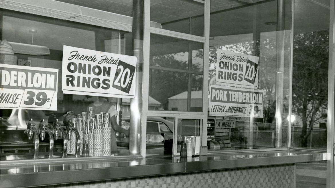 Exterior view of building with onion rings 20 cents sign.