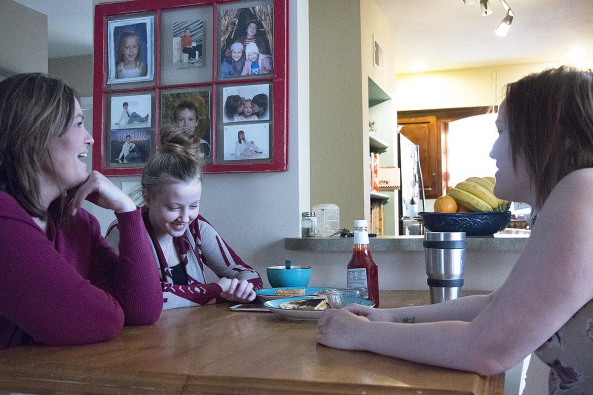 Dawn Myers and her daughters at their dining room table