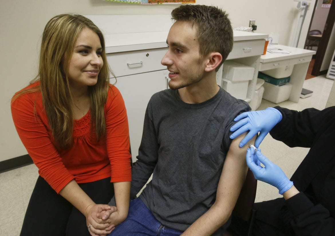 Until recently, there was no vaccine available in the US to help protect against meningococcal group B, one of the most prevalent types of meningococcal meningitis in the US. Leslie Meigs, meningococcal meningitis survivor and vaccination advocate, joins her brother Andrew (18) as he receives vaccination with Bexsero®, a meningococcal group B vaccine approved by the FDA for ages 10-25 in January. Bexsero is administered in two doses to help protect against the devastating disease, however is not expected to cover all group B strains. Bexsero is approved in more than 36 countries. For more information visit www.Bexsero-US.com. (Jack Plunkett/AP Images for Novartis Vaccines)