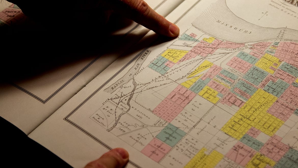 A man looks over an historical map in the Missouri Valley Special Collections
