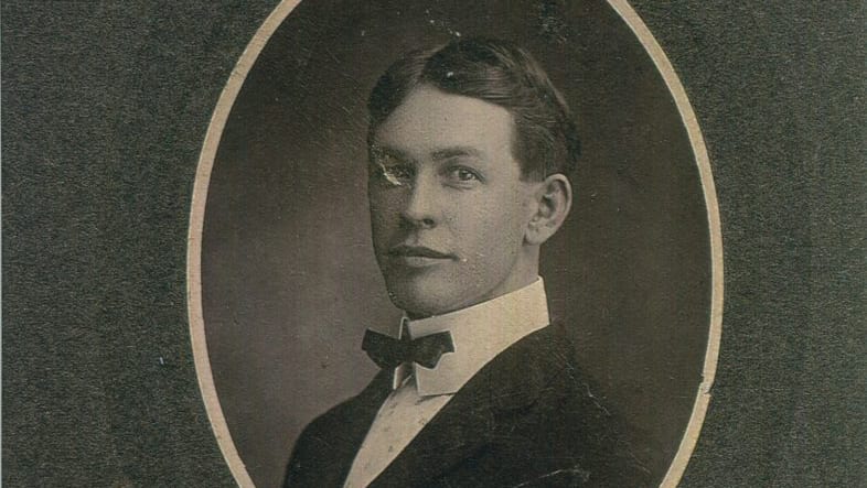 A black and white framed photo of a young man.