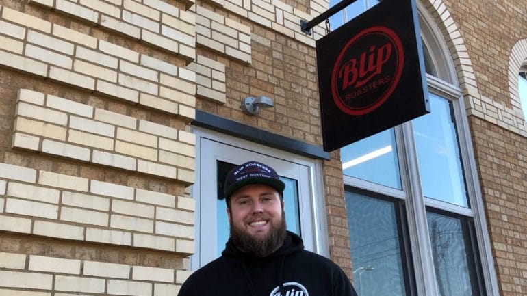 Ian Davis in front of the newly opened Blip Roasters Troost Avenue.