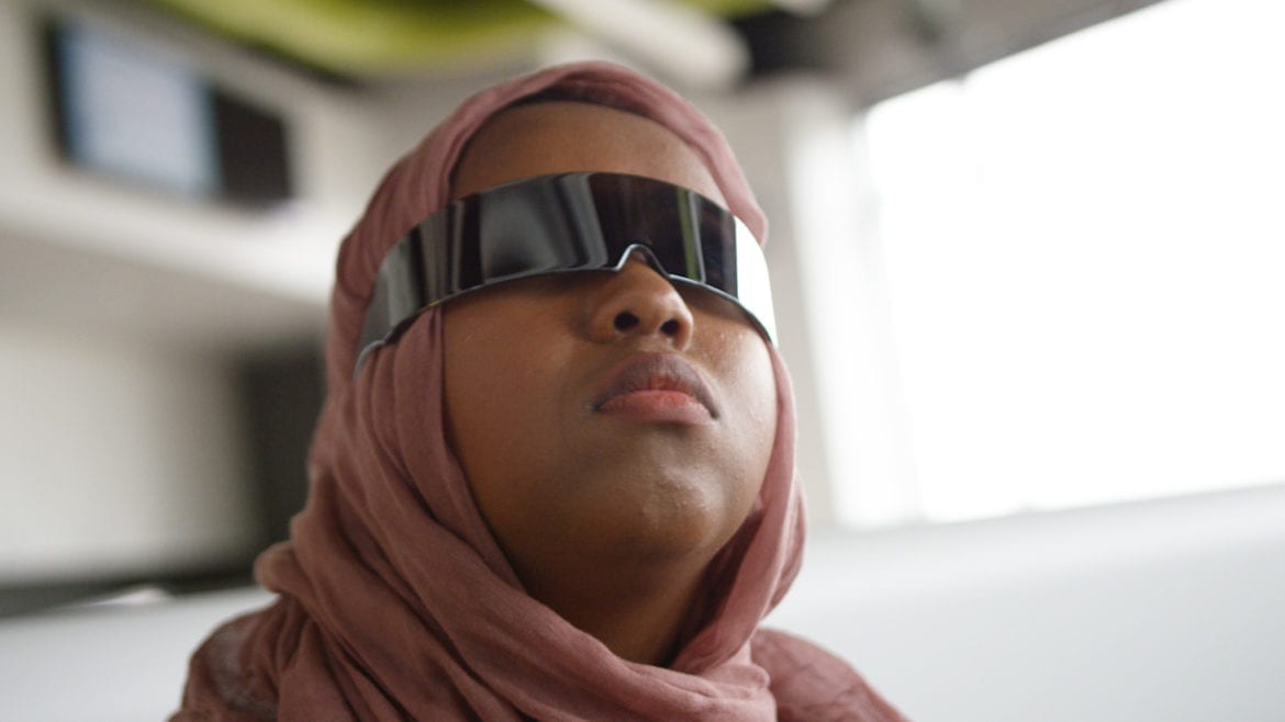 student with reflective glasses looking to the distance