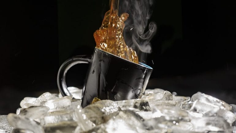 coffee pouring into a cup over ice