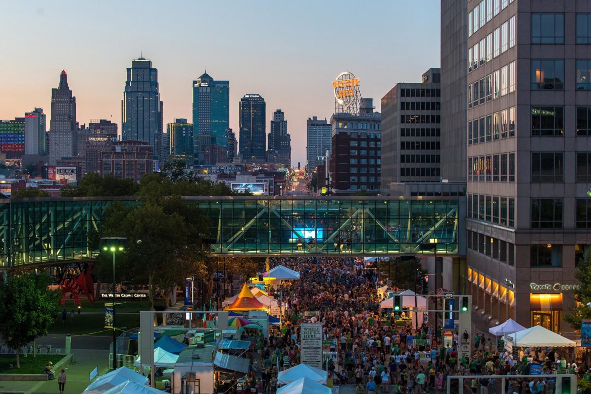 Irish Fest crowd gathers below the Kansas City skyline.