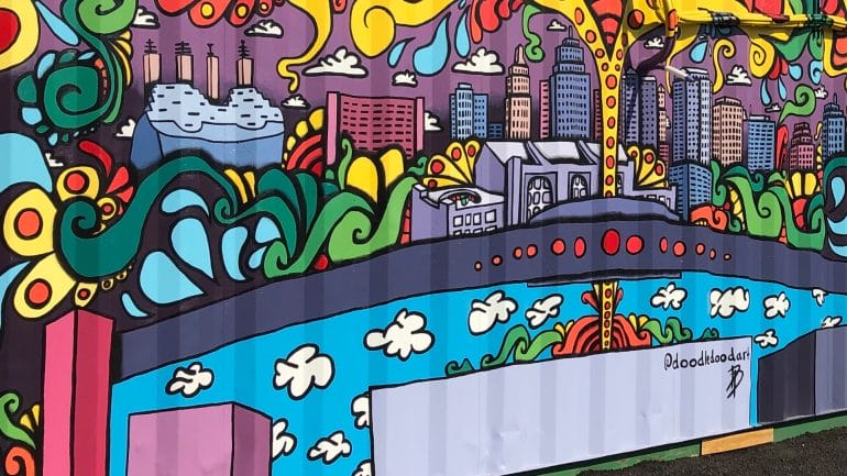 A mural of Kansas City painted on the side of a shipping container.