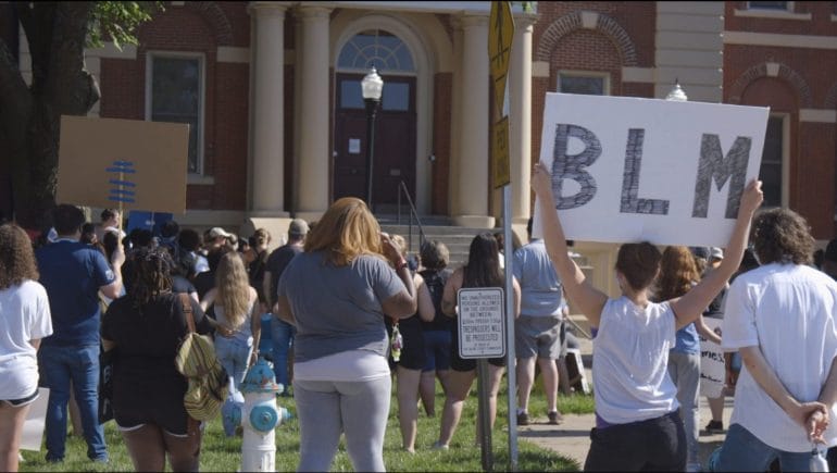 Protesters stand on the north lawn of the Saline County Courthouse in Marshall, Missouri on Sunday, June 7, 2020.