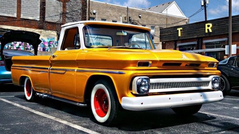 A classic yellow truck at Crossroads Cars in 2019.