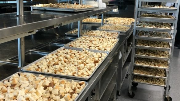 Trays of bread cubes dry in preparation for Thanksgiving stuffing.