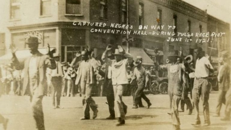 A picture postcard issued after the 1921 Tulsa race massacre depicted Black residents being led to the city’s convention hall.