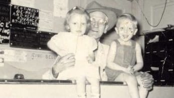 Della Reynolds (left) poses for a photo at The Dean Hotel front desk with her father Joseph Hagerty (center) and brother George (right) (Courtesy | Della Reynolds)