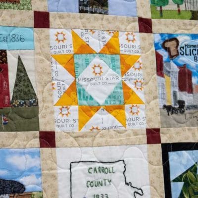 To make the quilt even, seven additional blocks were added with Missouri themes. Pictured here is a block by Courtenay Hughes for Missouri Star Quilt Co.
