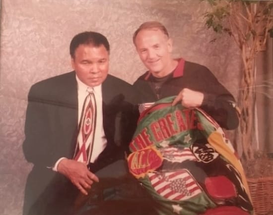 During Muhammad Ali’s visit to Kansas City in 2000, Kansas City area boxing coach and trainer John Brown presented him with a jacket bearing the words “Greatest Of All Time.”