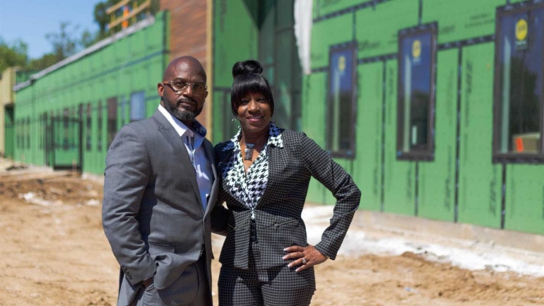 Myron McCant and Penny Dale-McCant pose in front of what will become the new KD Academy.